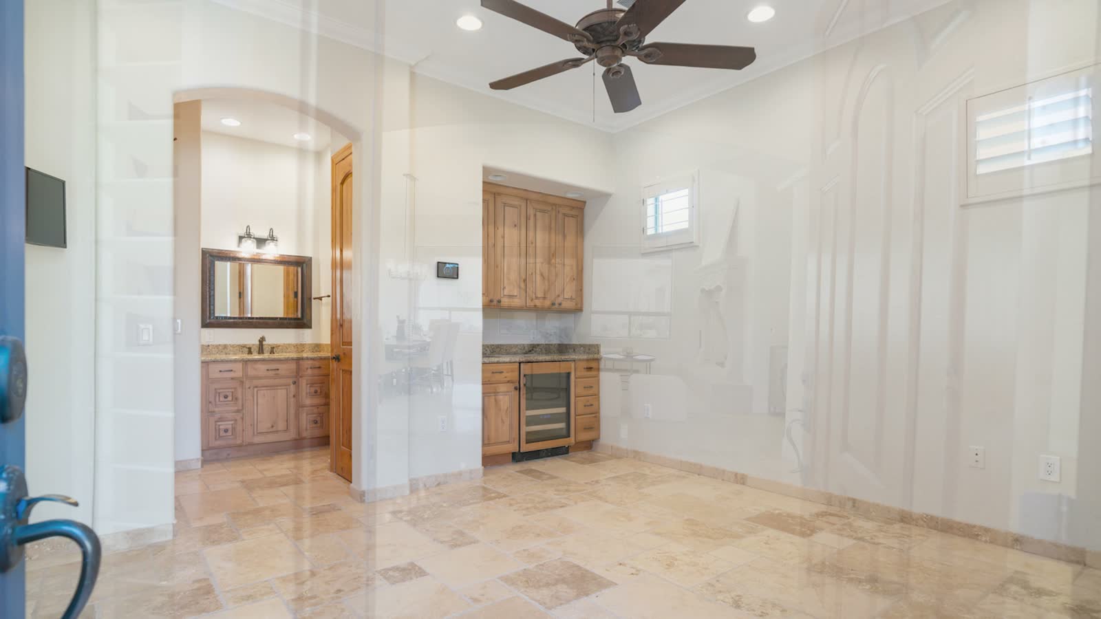 A great room with a stone fireplace and tall windows