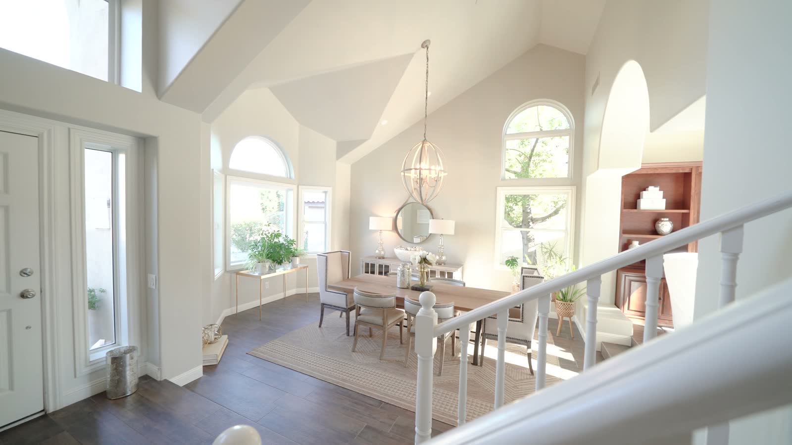 A two-storey entry hall with arched windows