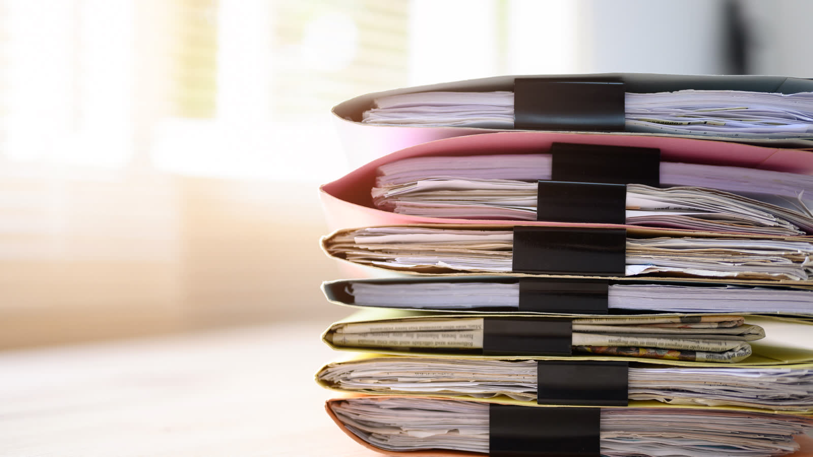 Documents filed in folders on a desk