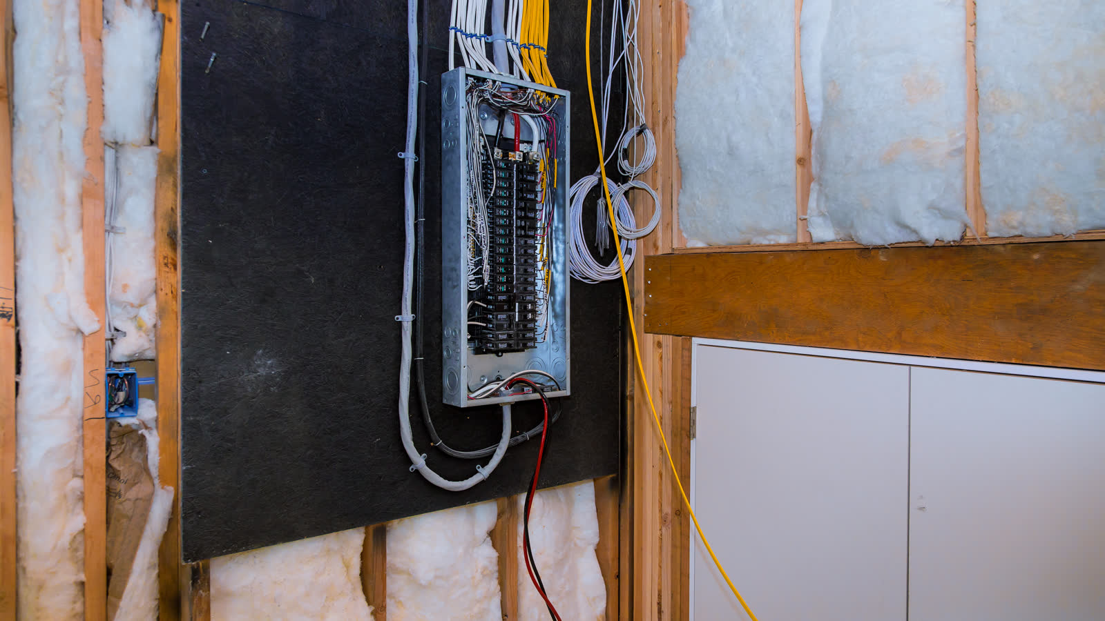 An open residential breaker panel with the wiring visible
