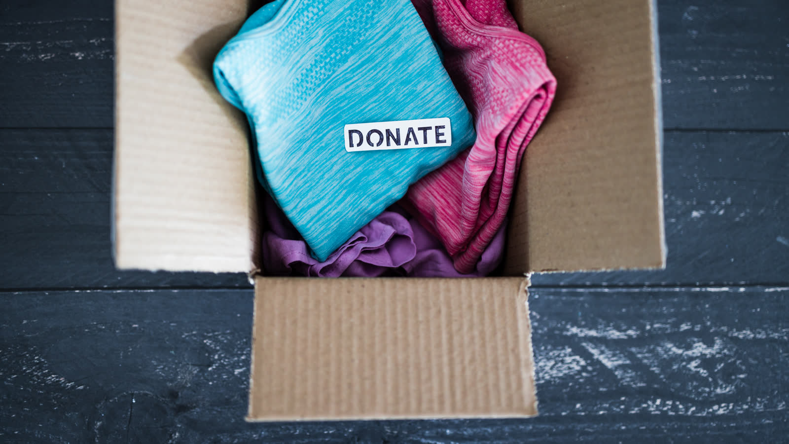 A box labelled for donation, packed with household items