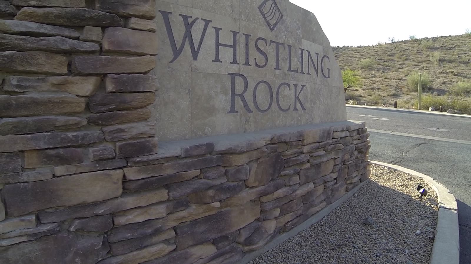 The Whistling Rock entrance monument, with the mountain behind